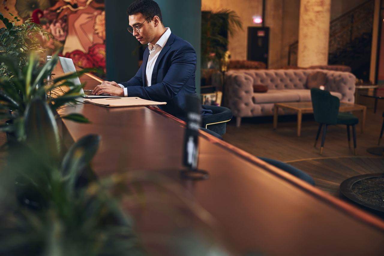 Guest working in a hotel lobby lounge
