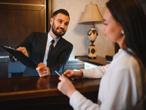 Guest checking in at a hotel front desk